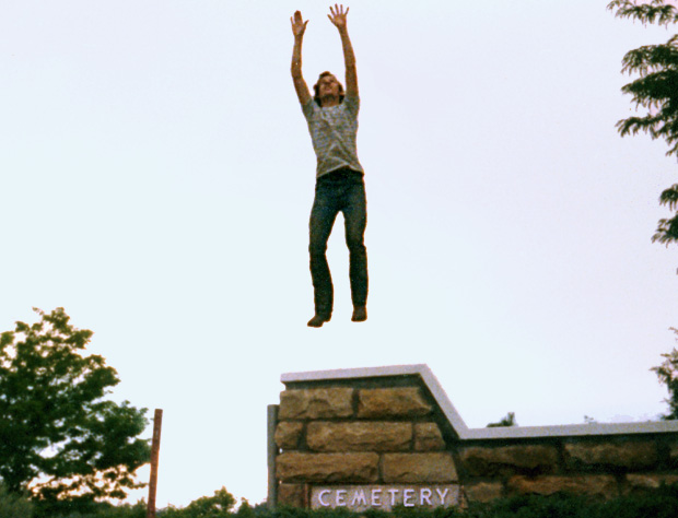 friend rising above cemetary wall